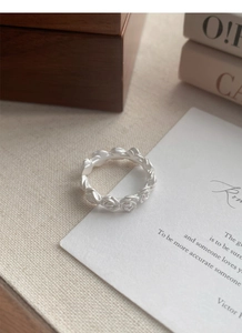 Close-up of matte S925 sterling silver ring with delicate rose flower relief pattern