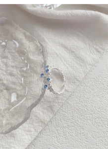 Macro detail of S925 silver ring featuring lava texture and blue zircon clusters