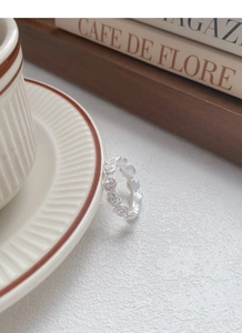 Macro detail of matte S925 sterling silver ring with 3D embossed rose flower carving