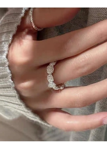 Close-up of S925 sterling silver vintage matte rose ring worn on finger with soft knit