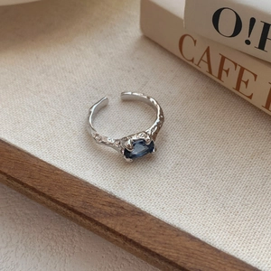S925 sterling silver open ring featuring irregular lava texture and an oval blue zircon