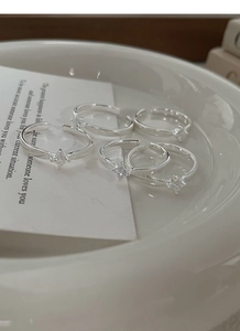 Macro detail of silver rings with feather texture and square cubic zirconia stones