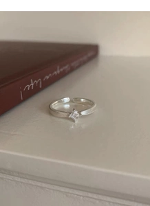 Detailed macro view of S925 silver ring featuring square zircon and textured woven band