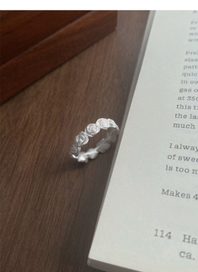 Macro shot of matte S925 sterling silver ring featuring vintage embossed rose patterns