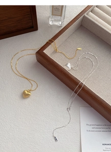 Detailed close-up showing the S925 sterling silver hallmark on brushed heart pendant necklace