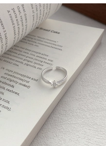 Detailed macro view of S925 sterling silver ring with square zircon on an open book