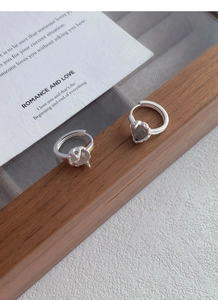 Detail of S925 silver hoop earrings with irregular grey moonstone on wooden tray