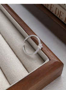 Detailed close-up of a S925 silver square zircon ring with wheat stripe engraving