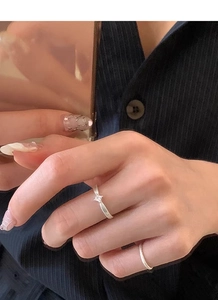 Detailed close-up of a silver S925 ring featuring a square cut zircon on finger
