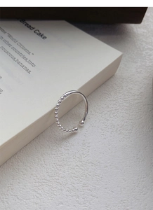 Macro detail of S925 sterling silver adjustable ring with bead splicing design