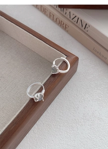 Macro shot of S925 sterling silver hoop earrings with natural labradorite on fabric tray