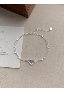 Detail of S925 sterling silver double-layer bracelet with heart moonstone on linen