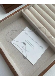 Close-up of S925 sterling silver heart necklace with double-ring clasp in a jewelry box