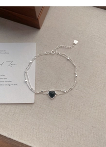 Detail of S925 sterling silver double-layer bracelet with black heart charm and beads