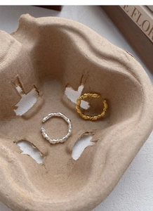 Detail view of gold and silver S925 sterling silver knotted twist rings in a vintage style