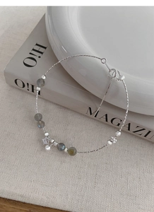 Close-up of S925 sterling silver bracelet with iridescent moonstones and star charm
