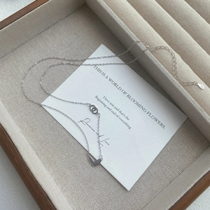 Minimalist S999 sterling silver heart necklace with interlocking rings and adjustable chain