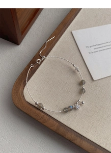 Macro view of S925 sterling silver chain with moonstone beads and star zircon pendant