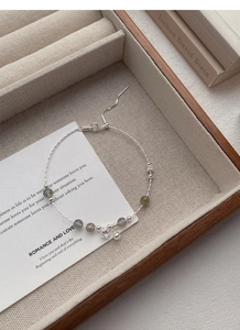 Detailed macro view of S925 sterling silver chain with moonstone beads and star charm
