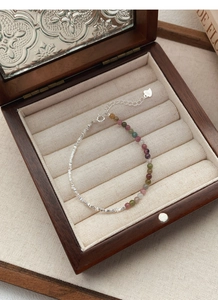Macro detail of S925 sterling silver beads and colorful tourmaline stone bracelet