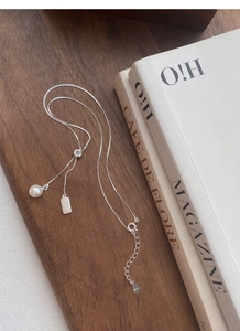 Detail of S925 sterling silver box chain necklace with pearl charm and adjustable sliding clasp