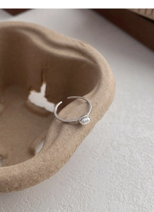 Detailed close-up showing the S925 hallmark and natural freshwater pearl on silver ring
