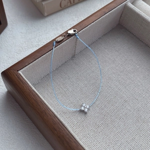 Elegant S925 silver four-leaf clover bracelet with light blue cord and sparkling zircons