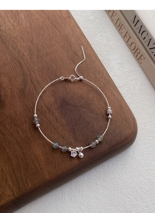 Detail of adjustable S925 sterling silver beaded bracelet with moonstone and star charm