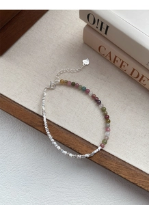 Detailed shot of S925 sterling silver bracelet with multi-color tourmaline beads and heart charm