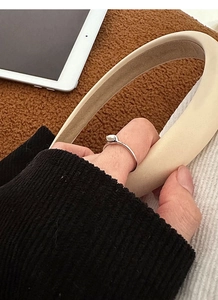 Detail of minimalist S925 silver ring with natural small pearls worn on a finger