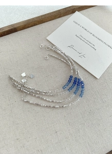 Detailed close-up of S925 sterling silver bracelets with blue crystal beads and heart charm