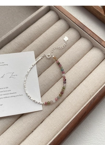 Detailed shot of S925 silver beads and multi-color tourmaline bracelet with heart charm