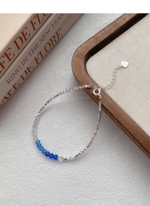 Close-up of S925 sterling silver heart tag and blue crystal beads on the beaded bracelet