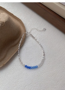 Detailed macro view of S925 sterling silver beaded bracelet with blue crystal accents