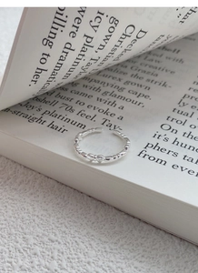 Close-up of S925 silver minimalist heart ring with adjustable bow-knot design