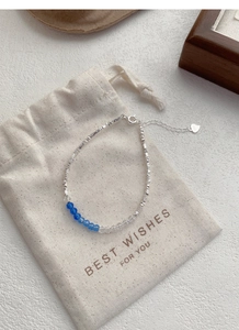 Detailed view of S925 sterling silver bracelet with blue crystal beads and silver flakes