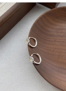 Macro detail of S925 sterling silver hoop earrings with translucent moonstone inlay