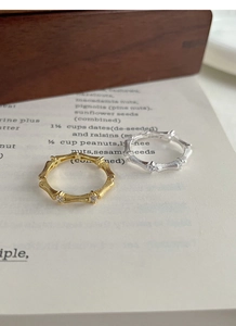 Macro shot of silver and gold bamboo style rings with sparkling cubic zirconia accents