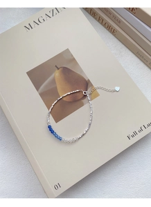 Detailed close-up of S925 sterling silver chain with blue crystal beads and extension link