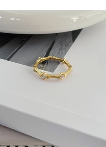Detailed close-up of a gold bamboo-style S925 silver ring with sparkling crystal accents
