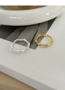 Detail of vintage bamboo silver and gold rings with brushed texture and tiny diamonds