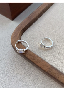 Close-up of S925 sterling silver hoop earrings with iridescent moonstone inlay