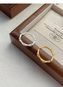 Detailed macro view of S925 silver bamboo rings with brushed texture and zircon inlay