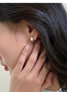 Macro detail of S925 sterling silver hoop earrings with cloud shaped mother of pearl