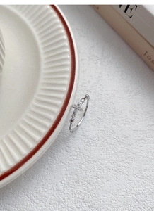 Close-up of S925 sterling silver cross ring with pavé zircons and beaded band details