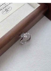 Macro shot of S925 silver ring featuring irregular organic texture and a zircon gemstone