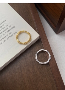 Detailed close-up of S925 silver bamboo rings with brushed texture and diamond accents