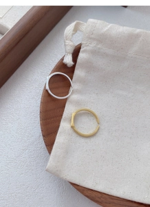Close-up of minimalist adjustable S925 sterling silver rings in gold and silver finishes