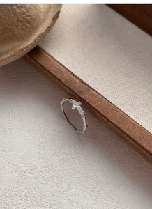 Detailed macro view of S925 sterling silver bamboo cross ring with sparkling zircon stones