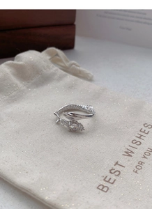 Detailed macro of S925 sterling silver snake ring with marquise zircon on a gift pouch